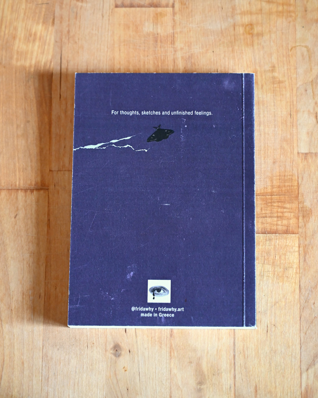 Blue notebook with minimal design on a wooden surface