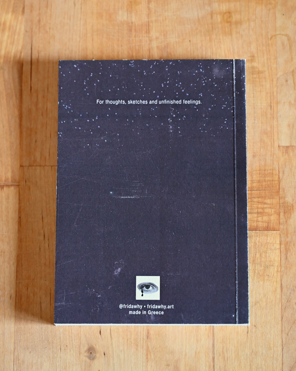 Notebook with starry night design on a wooden surface