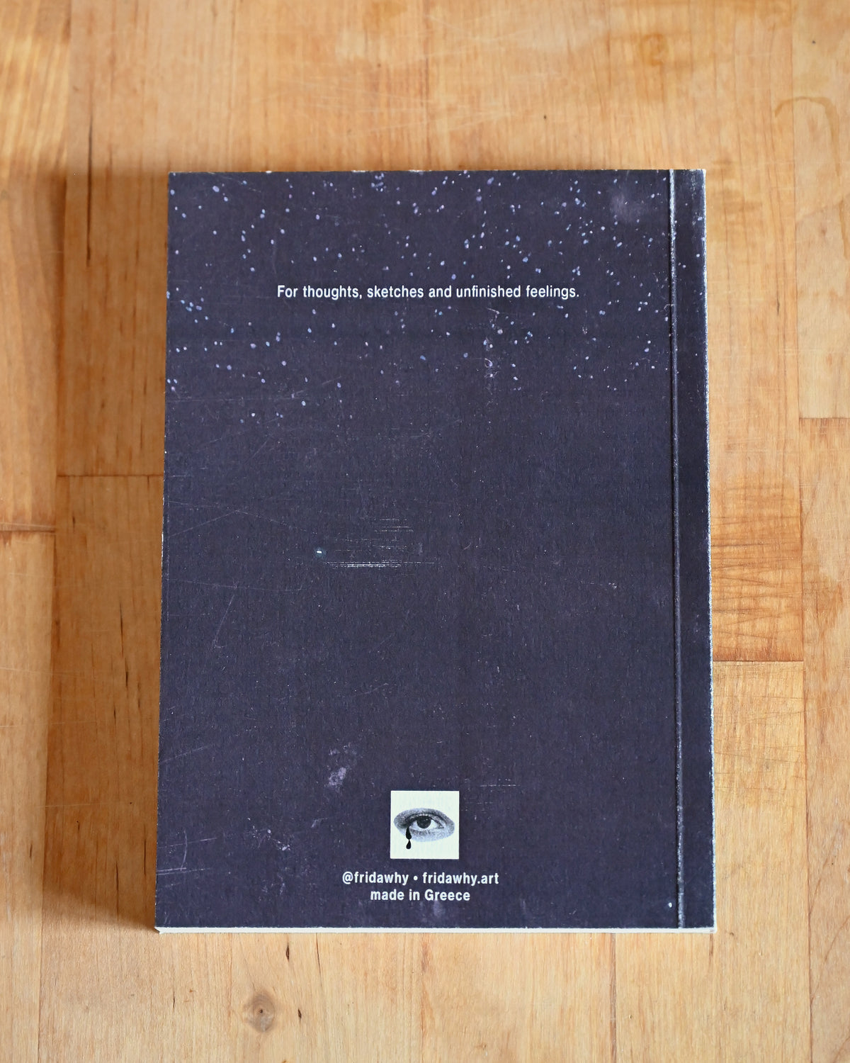 Notebook with starry night design on a wooden surface