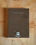 Brown notebook with text on a wooden surface