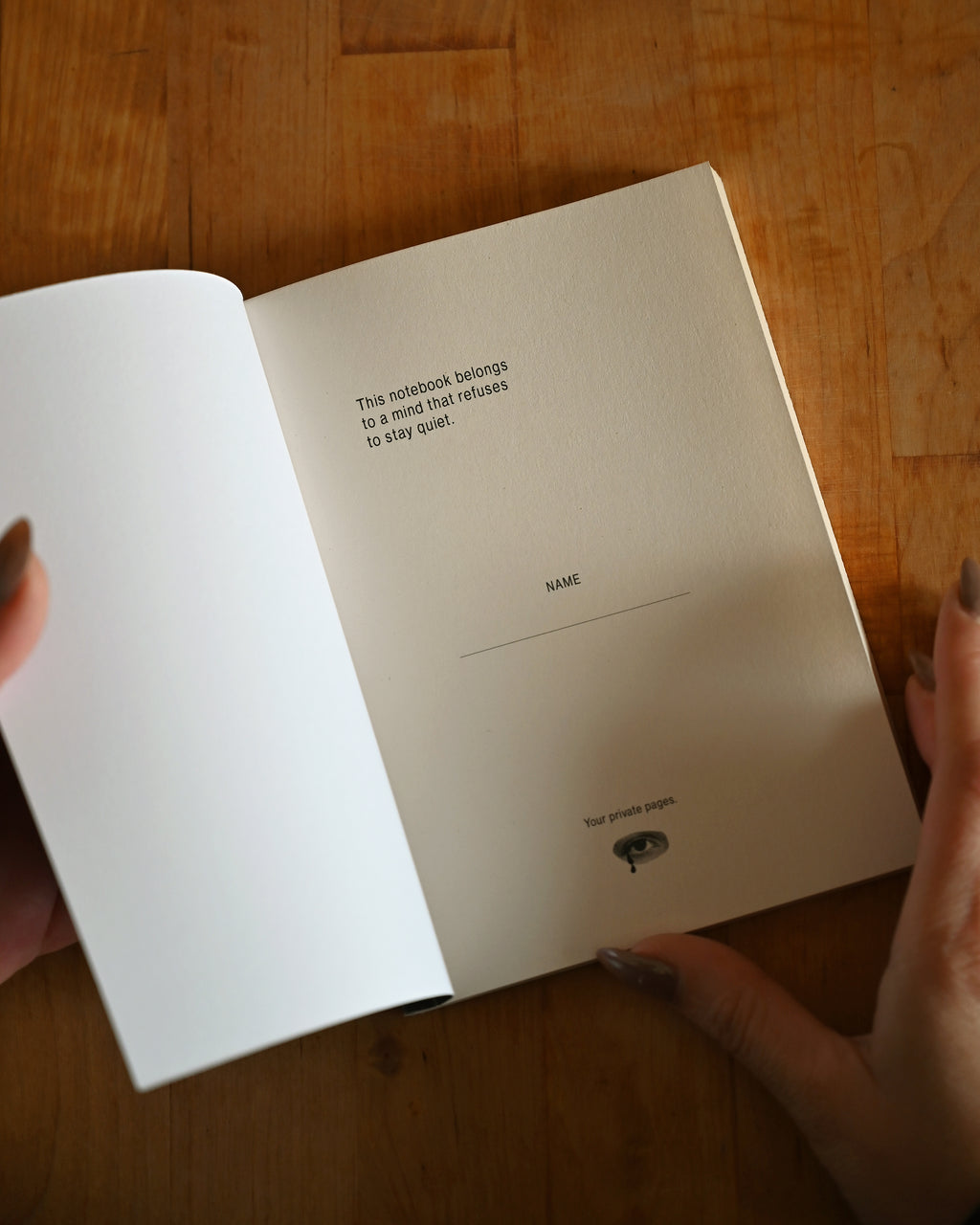 Open notebook with text on a wooden surface