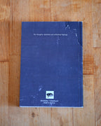 Blue notebook with text on a wooden surface