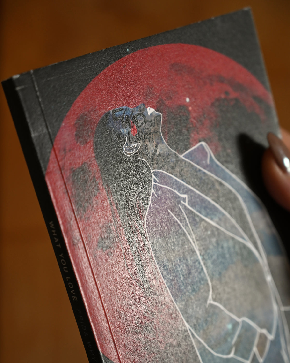 Book with a red and black cover featuring an abstract design