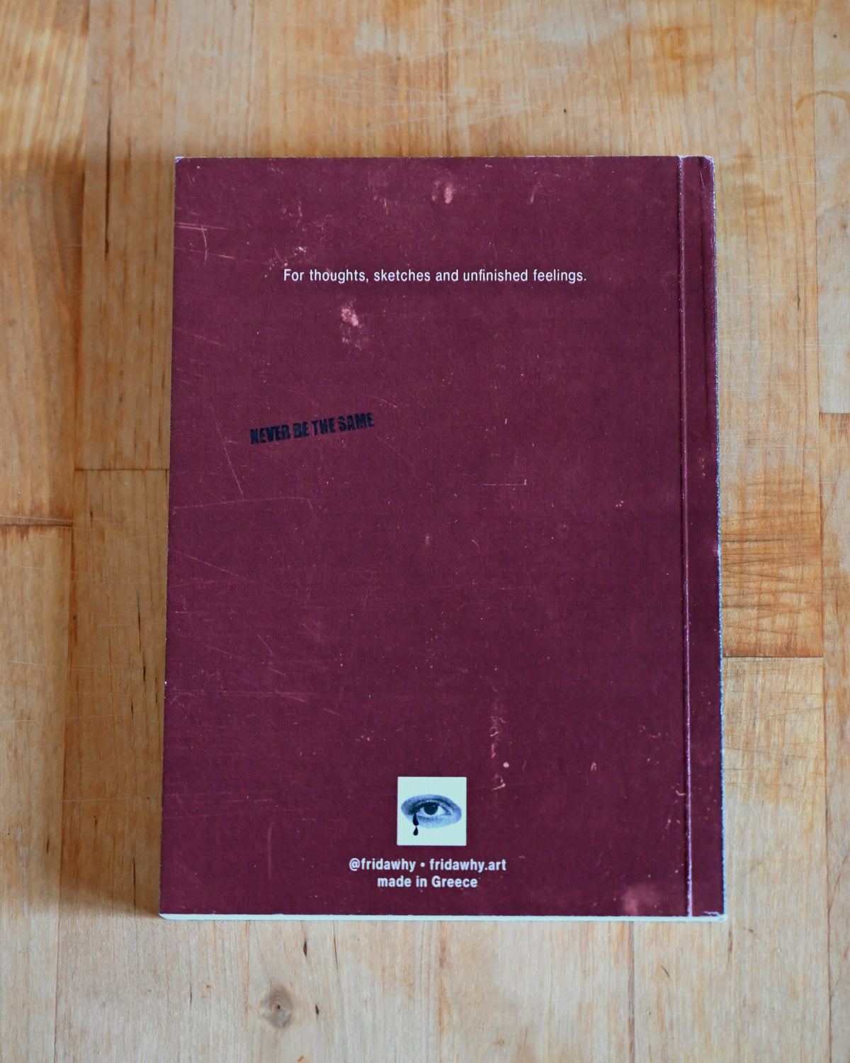 Purple notebook with text on a wooden surface