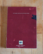 Red notebook with text on a wooden surface