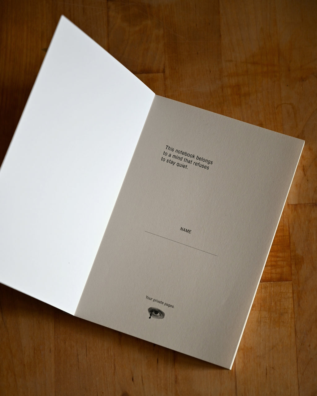 Notebook with text on a wooden surface