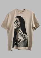 A beige short-sleeve t-shirt featuring a black and white graphic print of a stylized Mona Lisa face with the word 'Fiction' written across her chest, displayed against a solid gray background.