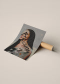 A rolled sheet of printed art or poster paper lies on a cardboard tube, partially unrolled to show an abstract portrait illustration with the word 'Freedom' written across it.