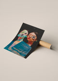 A printed art poster or photo print with a surreal portrait of two faces, one with a teal mask and the other with a flower over one eye, leaning against a cardboard mailing tube on a warm beige background.