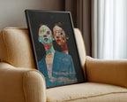 Framed artwork of two stylized faces on a beige armchair.