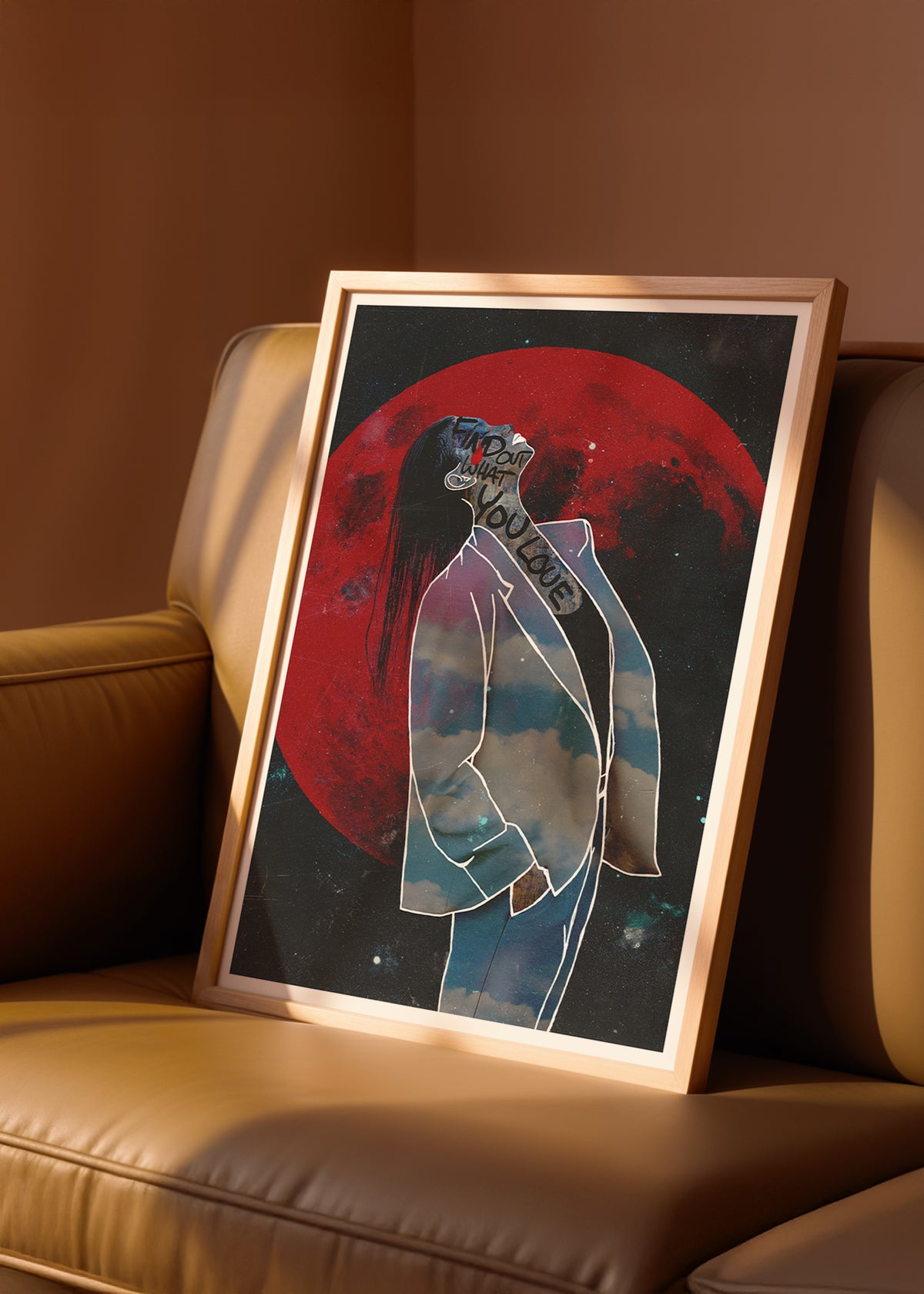 Framed collage sureal artwork of a stylized woman's figure with a red moon in the background on a beige couch.