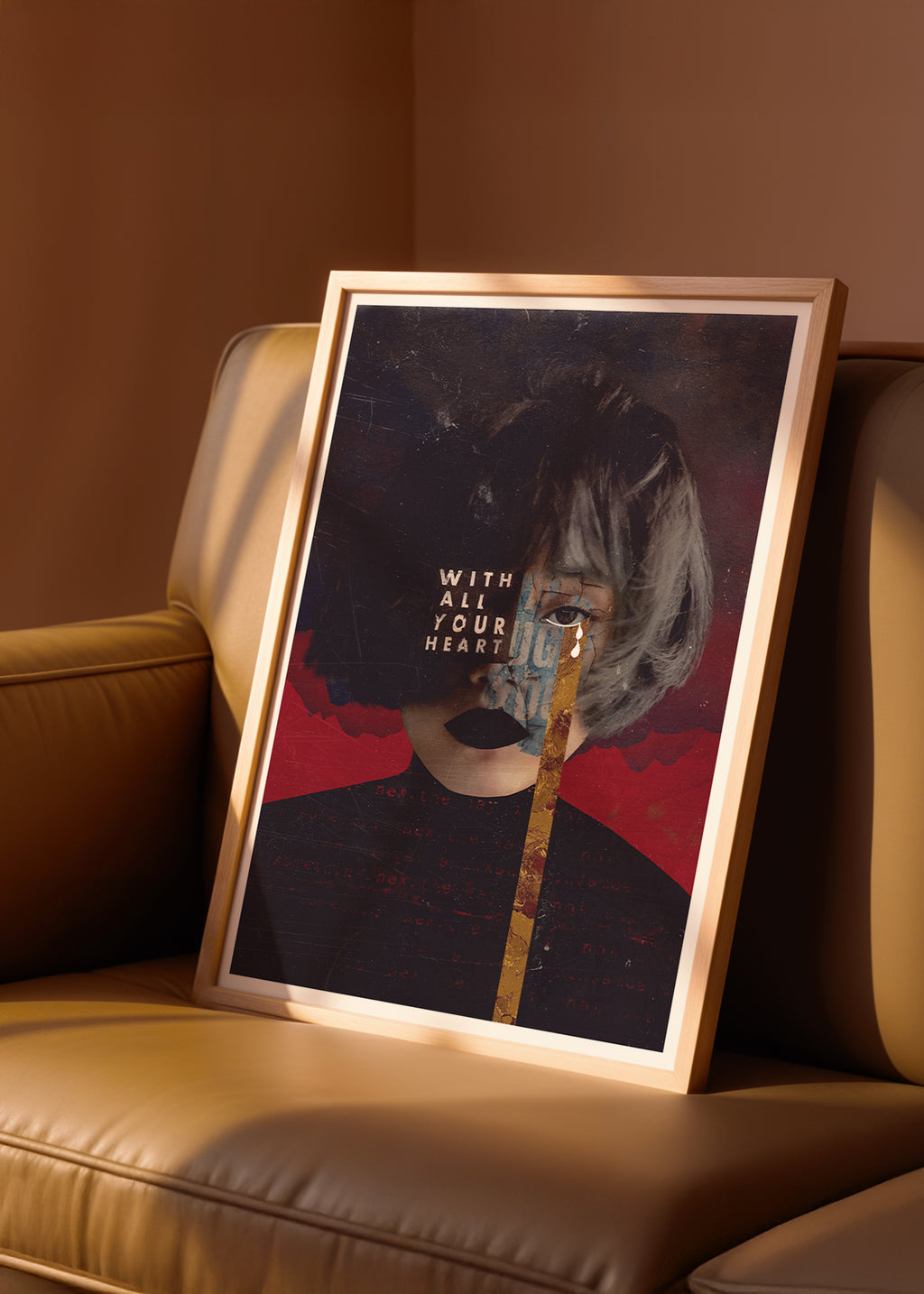 Framed collage artwork with a stylized portrait on a beige sofa