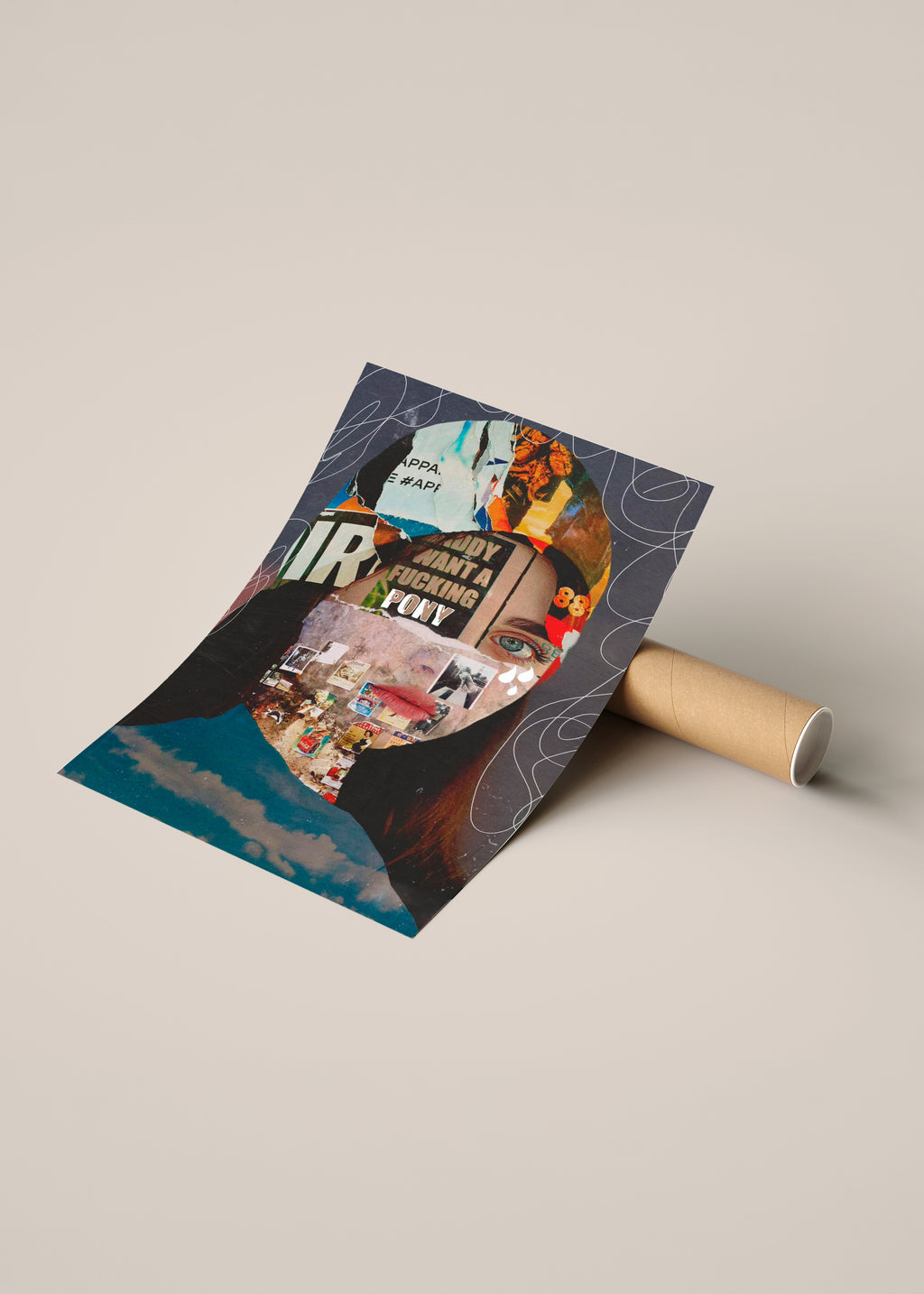 A rolled poster or art print lies on a cardboard tube, partially unrolled to reveal a collage-style design of a portrait with text, illustrated figures, and dark blue abstract shapes.