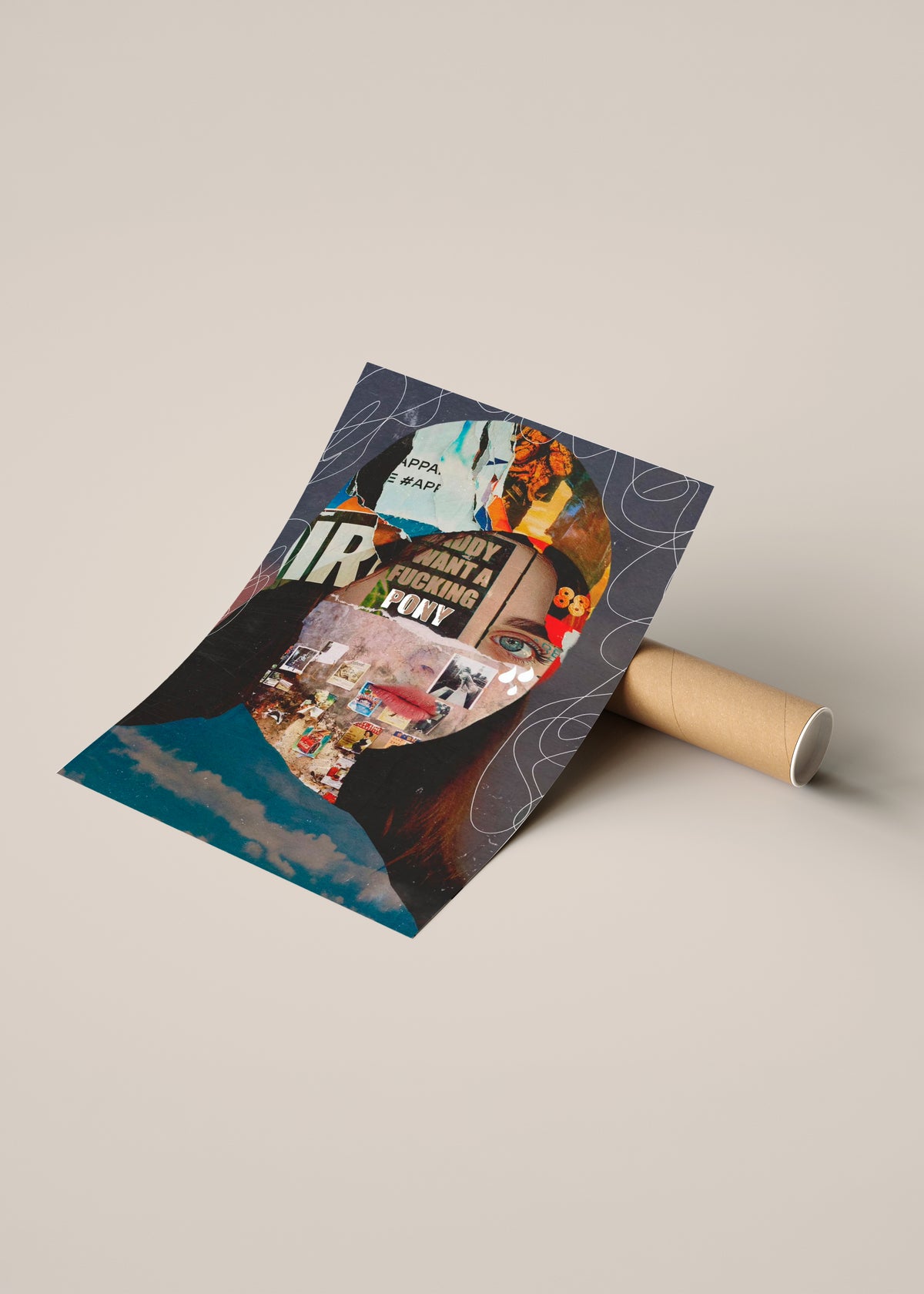 A rolled poster or art print lies on a cardboard tube, partially unrolled to reveal a collage-style design of a portrait with text, illustrated figures, and dark blue abstract shapes.