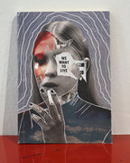 A square canvas art print featuring a surreal collage portrait of a woman with red, white, and black elements, set against a gray background with white wavy lines. The print is displayed standing on a red reflective surface against a white wall.